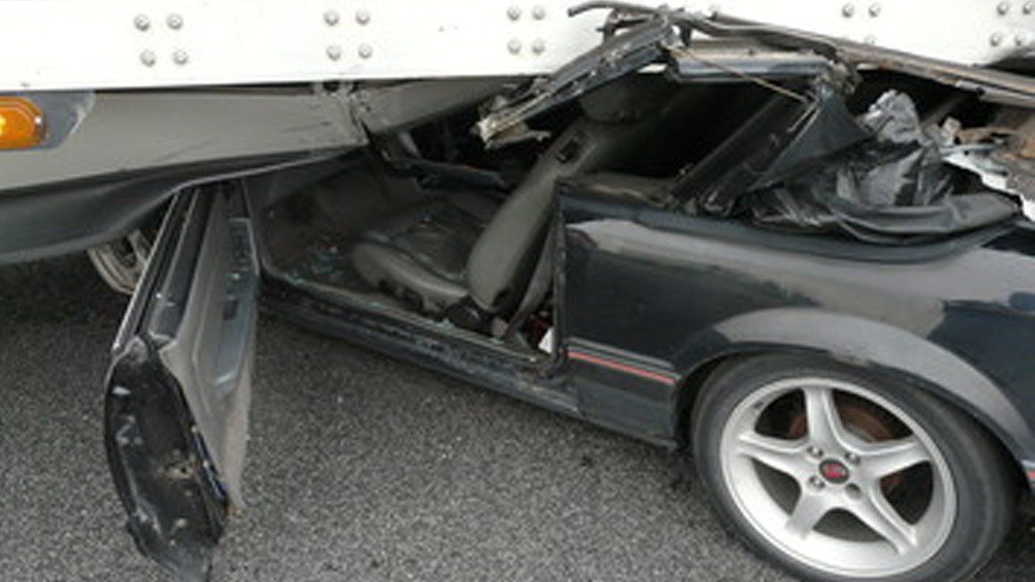 man driving mustang caught under moving semi-truck in Indiana