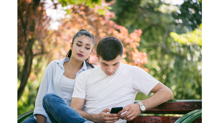 Young woman Spy on Boyfriend Cell Phone