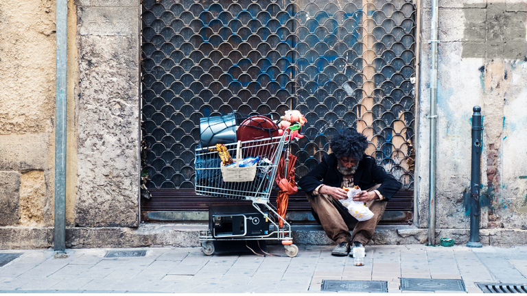 Homeless man asking for money at the street