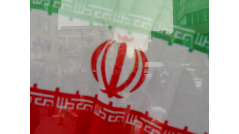 Iran flag oblique and people behind - Tehran