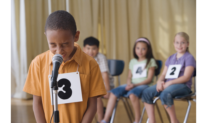 African boy giving answer in spelling bee