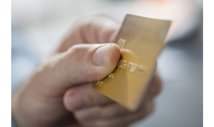 Man's hand holding credit card, close-up