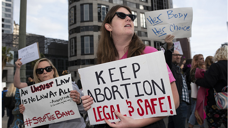 Activists are seen holding placards during the protest.