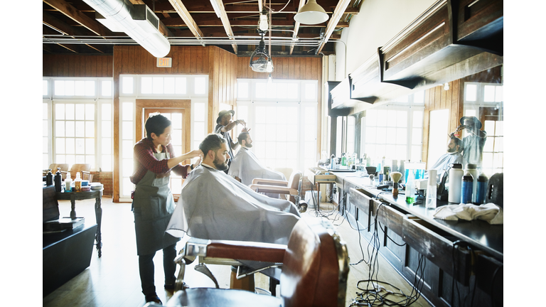 Clients having their hair cut in barber shop