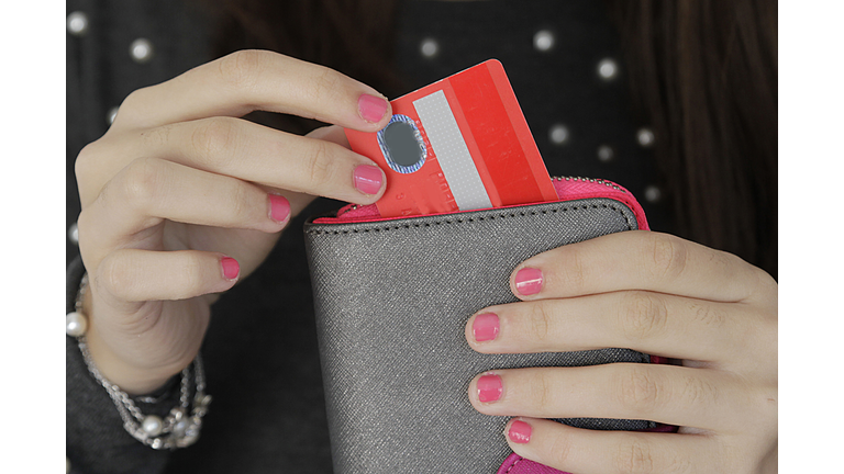 Woman pulling credit card out of purse