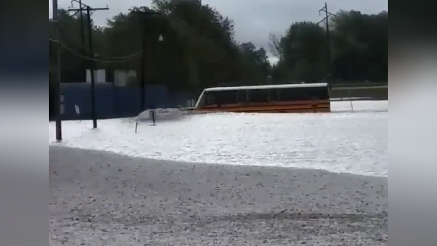 bus drives through flooded intersection with students on board