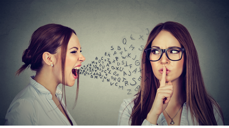 Angry woman screaming at herself with finger on lips gesture