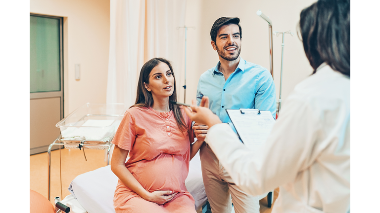 Husband and wife talking to the doctor in the hospital