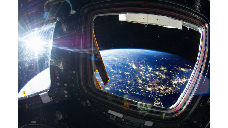 Collage image with huge US at night with city lights from the outer space from the ISS window. Elements of this image furnished by NASA. ( Elen11/Getty Image)