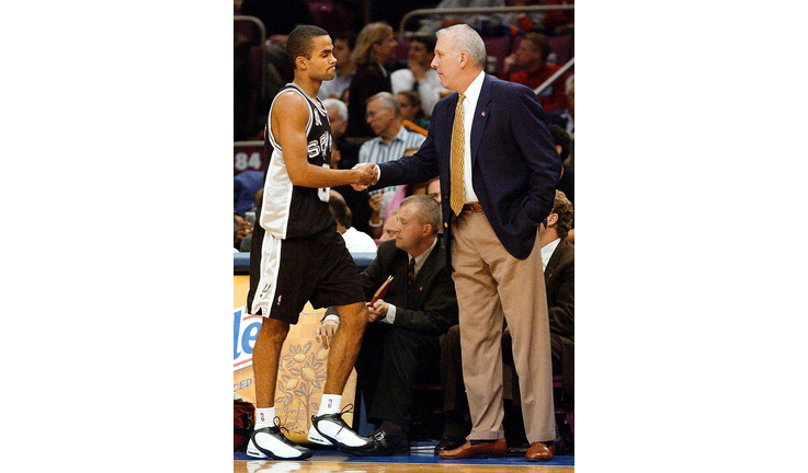 Tony Parker of the San Antonio Spurs (L) gets a ha