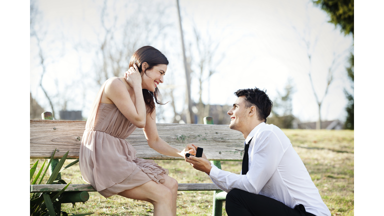 Man proposing to girlfriend at park