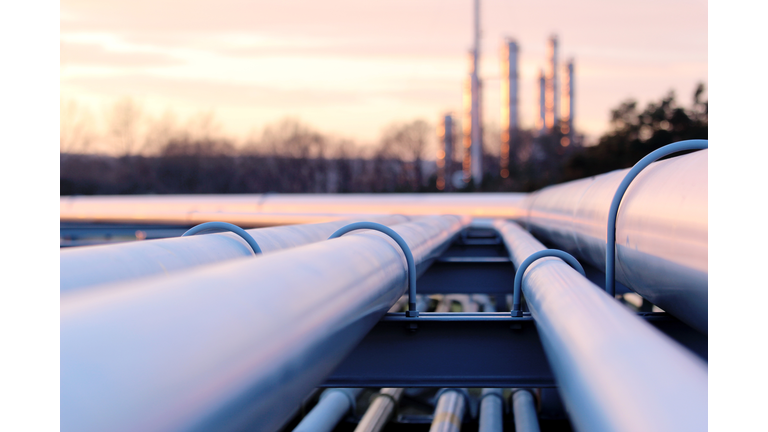 steel long pipes in crude oil factory during sunset