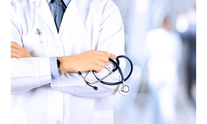 Portrait an unknown male doctor holding a stethoscope behind