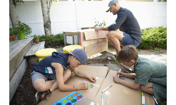 Father and sons making lemonade stand