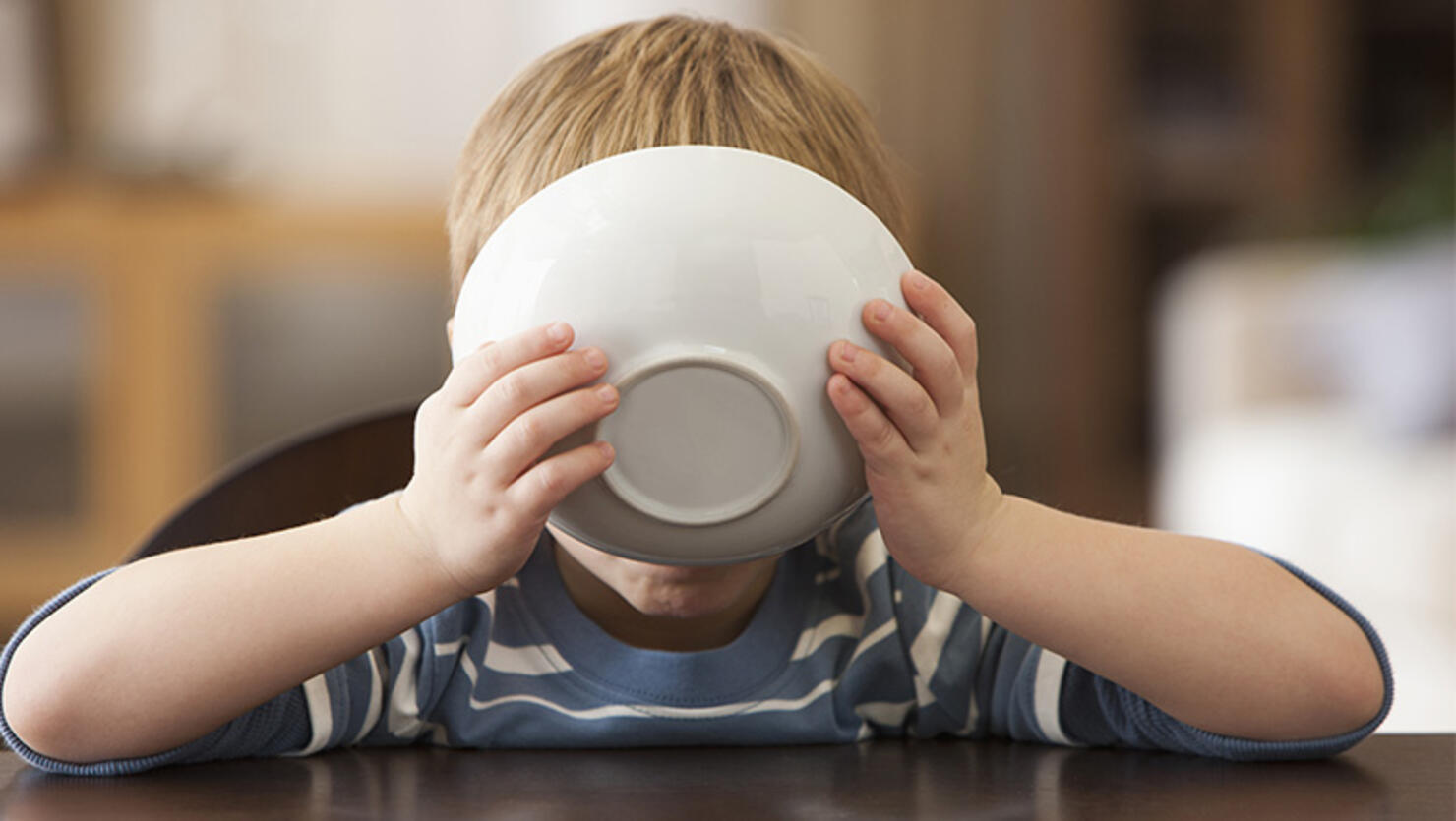 Young boy eating from bowl