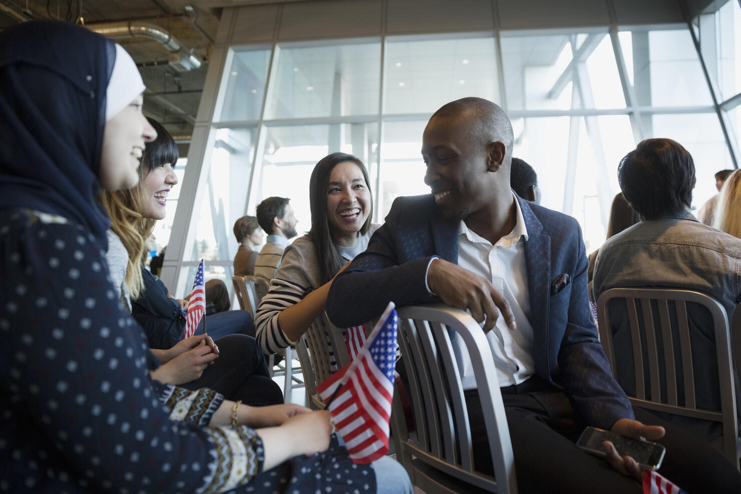 Young people with American flag talking political rally