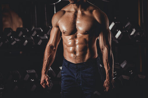 Muscular Man Standing In The Gym