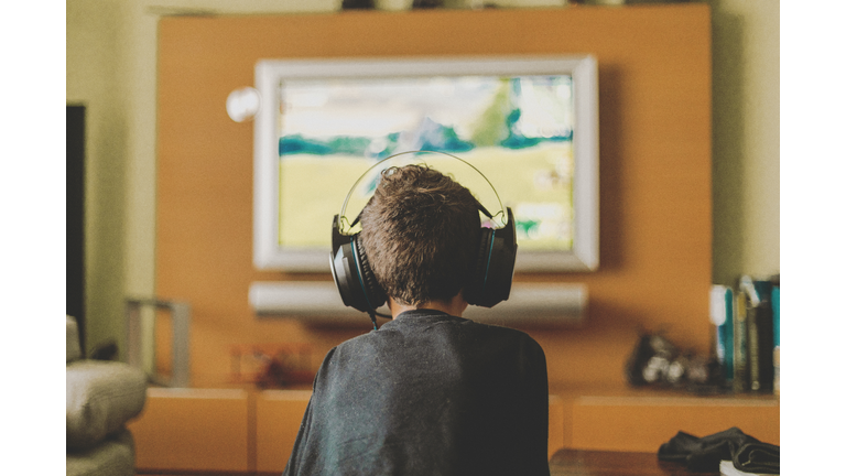 boy enjoying game console at home.Rear view