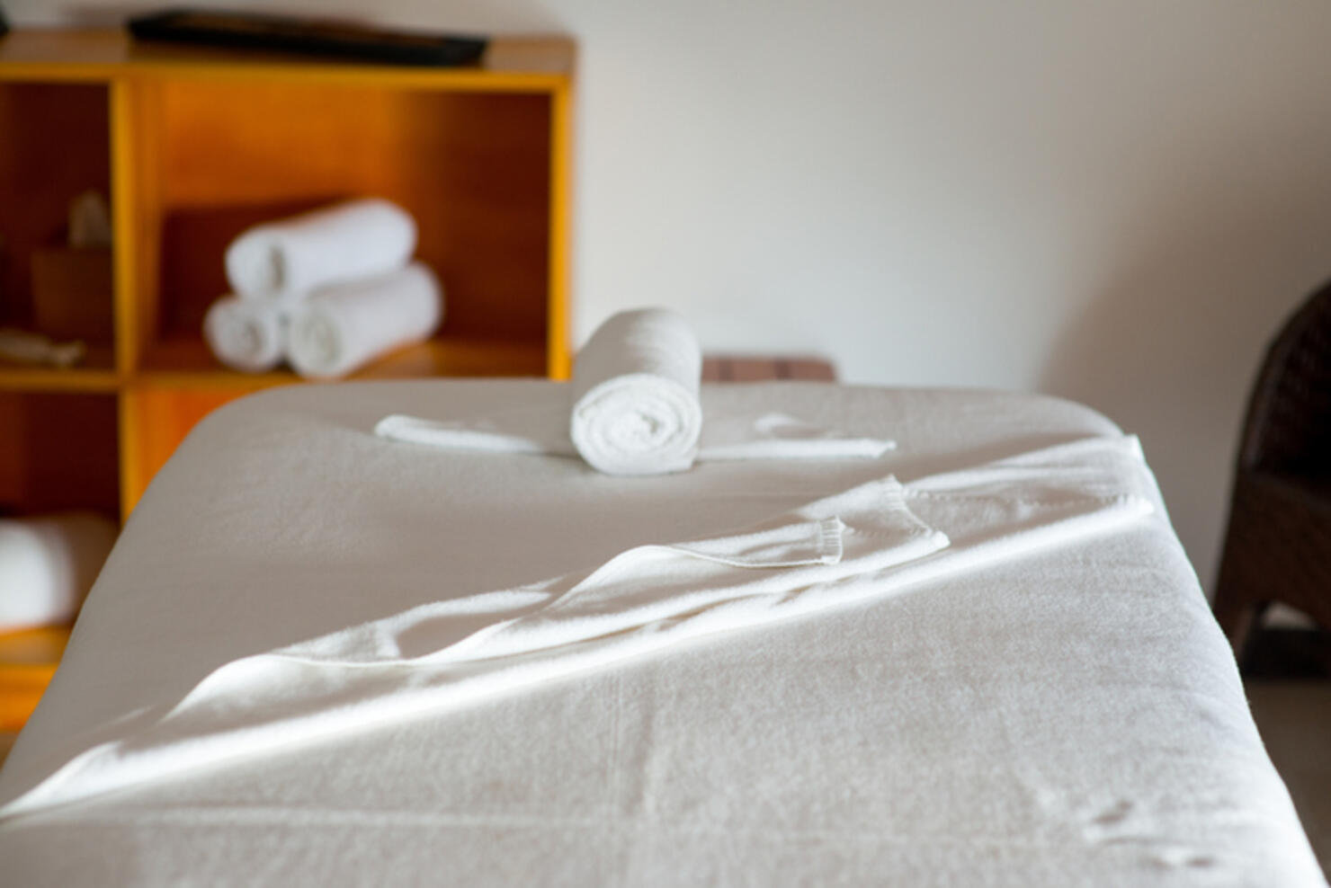 rolled towel on massage table