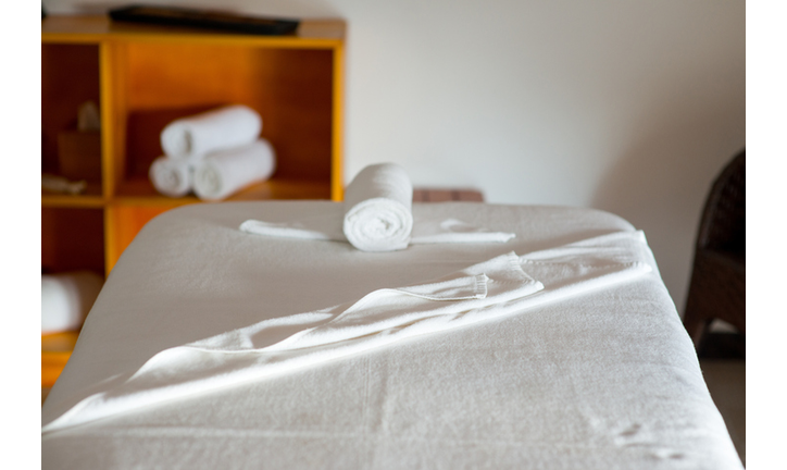 rolled towel on massage table