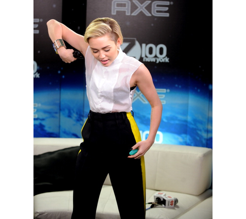 Here's Miley trying on some Ax body spray.