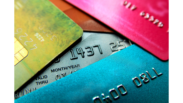 Stack of multicolored credit cards close-up view with selective focus.