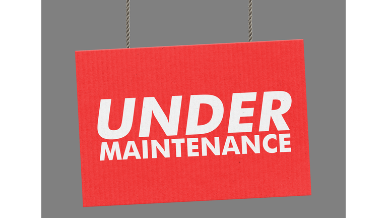 Under maintenance sign hanging from ropes. Clipping path included so you can put your own background.