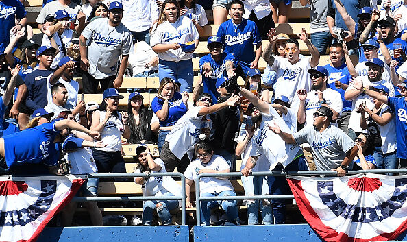 Dodger fan gets hit in the face with baseball.