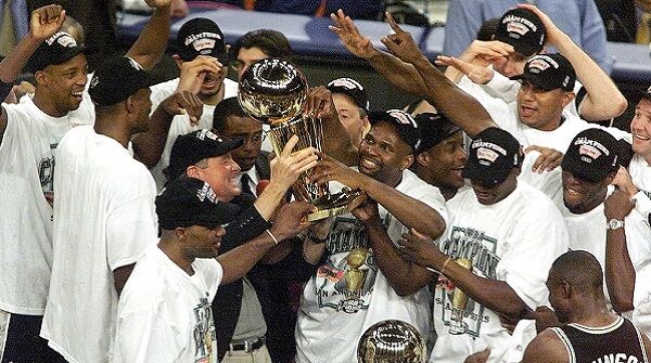 The San Antonio Spurs team gathers around the cham