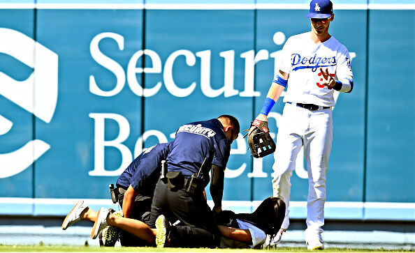 Another female fan interrupted a game by running on the field in attempt to hug Dodgers star Cody Bellinger.