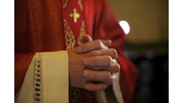 Catholic priest on altar praying during mass