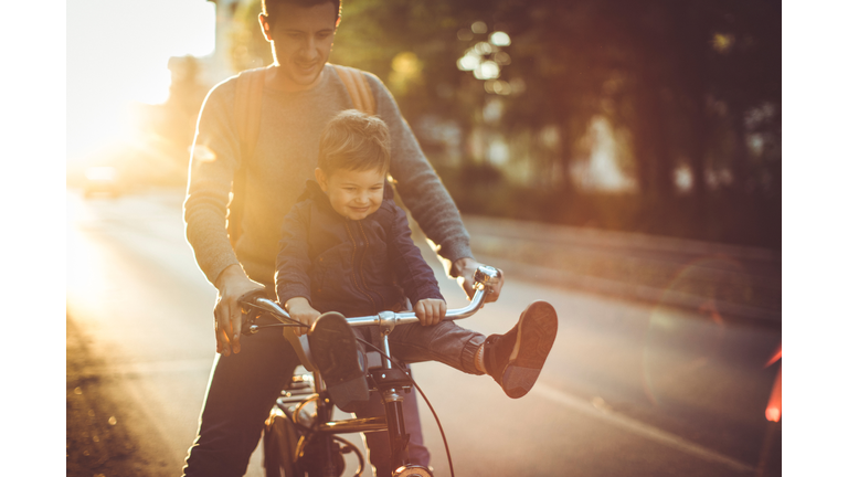 Young cyclist and his father