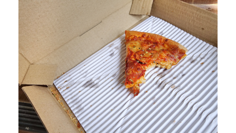 Leftover pizza in box