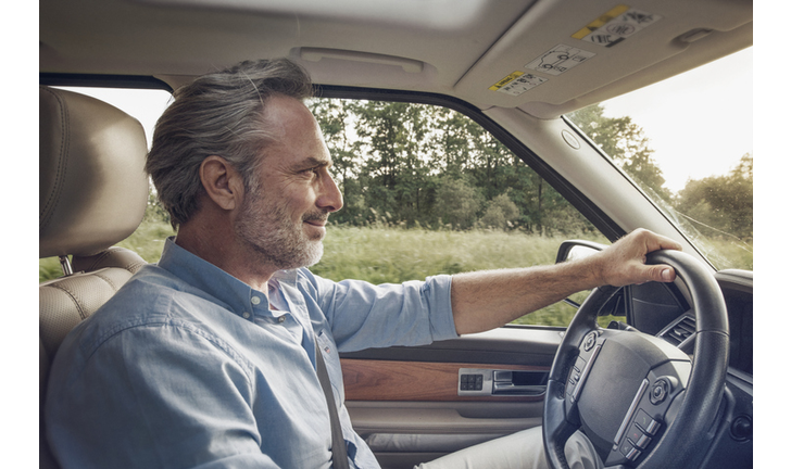 Mature man driving car