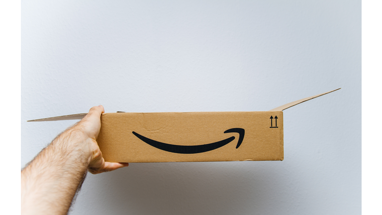 Amazon cardboard box against white background in hand