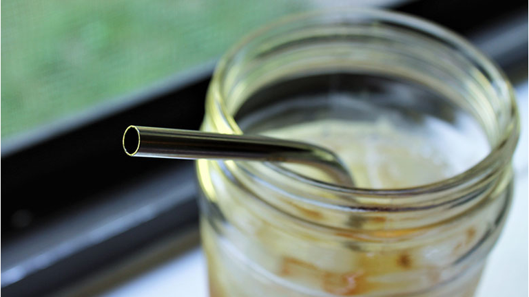Ice tea in glass with metal straw