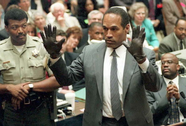 O.J. Simpson shows the jury a new pair of Aris ext