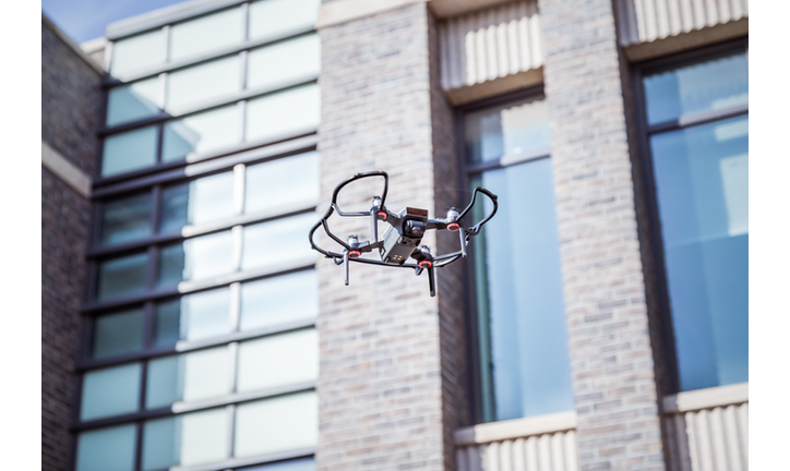 Drones fly in cities.