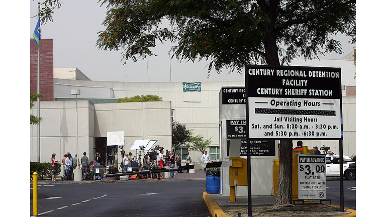 Media crews work at the entrance of the