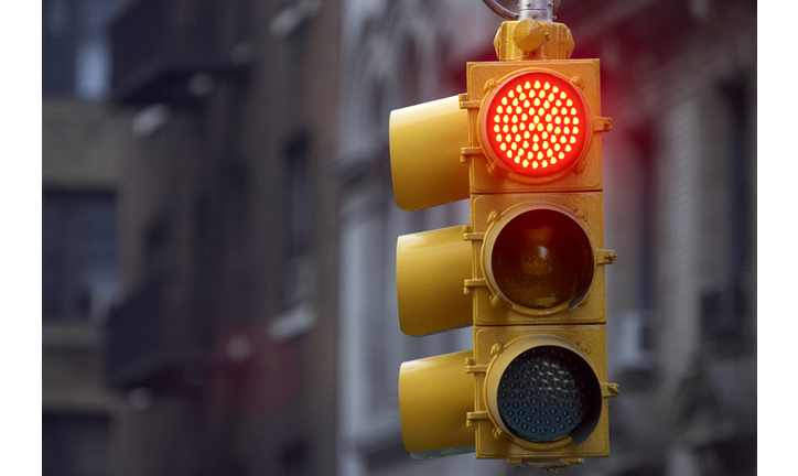 Traffic light on street with red signal lit up