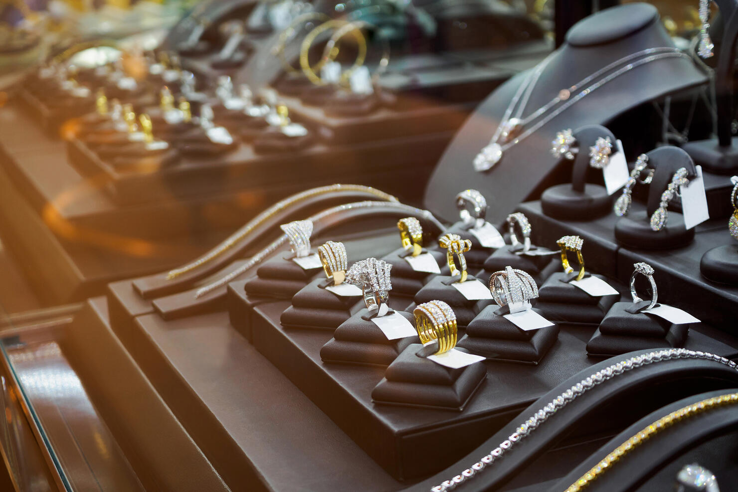 Gold jewelry diamond shop with rings and necklaces luxury retail store window display showcase