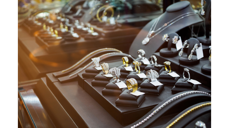 Gold jewelry diamond shop with rings and necklaces luxury retail store window display showcase