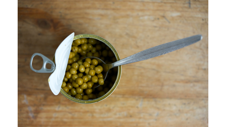 Directly Above Shot Of Canned Peas With Spoon On Table