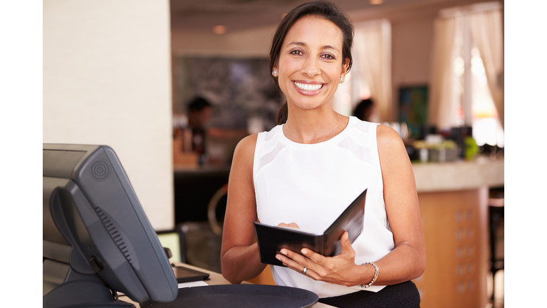 Portrait Of Waitress In Hotel Restaurant Preparing Bill