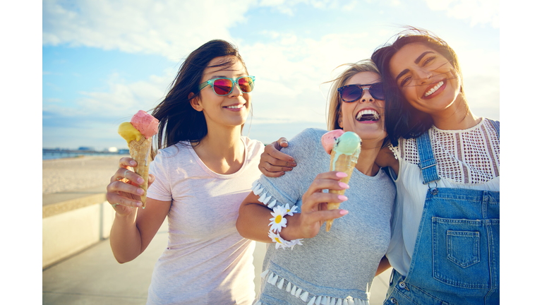 Laughing teenage girls enjoying ice cream cones