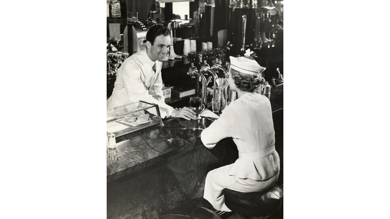 Woman sitting at lunch counter