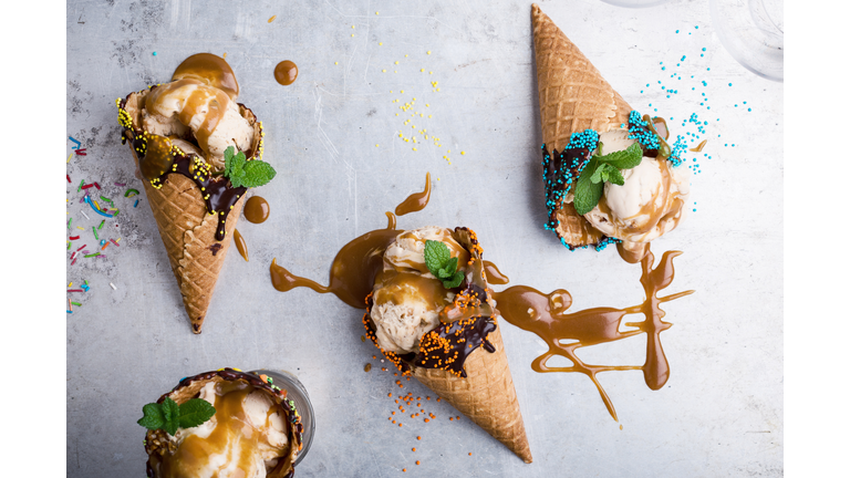 Ice cream with caramel sauce in waffle cone