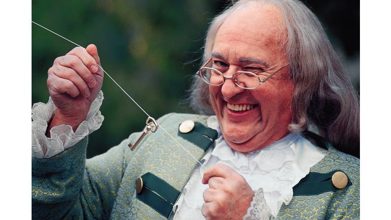 Portrait of man dressed as Benjamin Franklin with key and kite