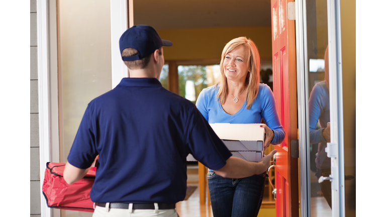 Take-out Pizza Delivery Man at Customer's Door -getty images