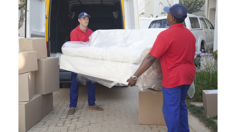 Movers carrying sofa to new home